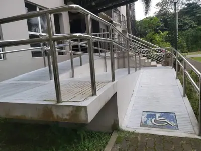 a staircase with a metal railing next to a building at Affordable Tagaytay Monteluce 2 BR with Pool G28 in Silang
