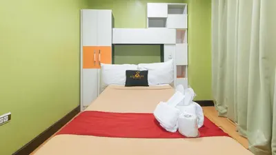 a small room with a bed with at 153 Silverio Suites Paranaque City in Manila