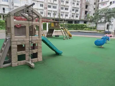 a playground with a slide and a play structure at Affordable Tagaytay Monteluce 1 BR WITH POOL-224 in Lalaan Primero