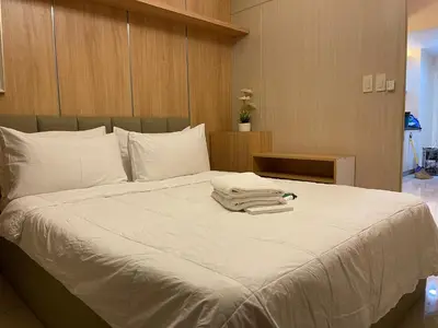 a bed with two towels on top of it at Netflix- Destina Stays at Jazz Residences Makati, MetroManila in Manila