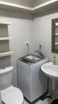 a bathroom with a toilet and a sink at Netflix- Destina Stays at Jazz Residences Makati, MetroManila in Manila