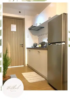 a kitchen with a stainless steel refrigerator next to a door at Bethel House in Manila