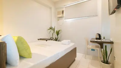 a small room with a bed and a desk at UrbanView at San Antonios Place Sampaloc Manila in Manila