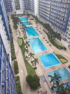 an aerial view of three swimming pools in a city at Blue's Residences in Manila