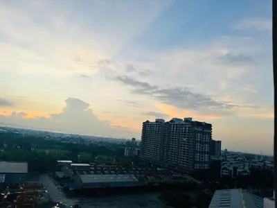a view of a city at sunset with buildings at 1 Bedroom with balcony Near Airport Bgc Taguig City in Manila