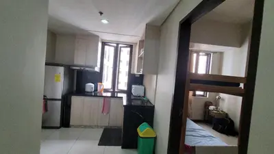 a small kitchen with a sink and a refrigerator at MANILABAY HOME in Manila