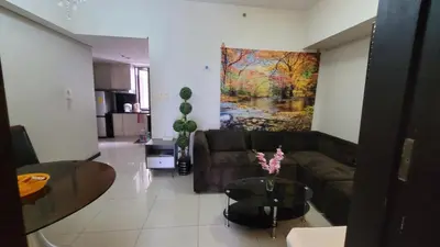 a living room with a couch and a table at MANILABAY HOME in Manila