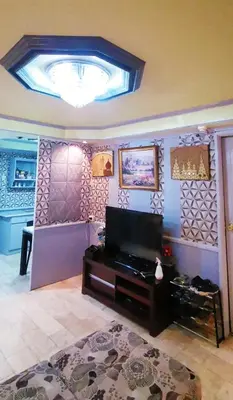 a living room with a flat screen tv on a wall at City Tower Condominium Transient Inn in Manila
