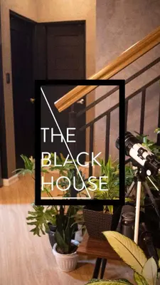 a sign that says the black house next to plants at The Black House in Dulong Bayan