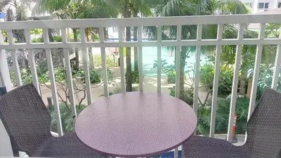 a purple table and chairs on a balcony at SHORE RESIDENCE D4 shortwalk MALL OF ASIA NEAR AIRPORT in Manila