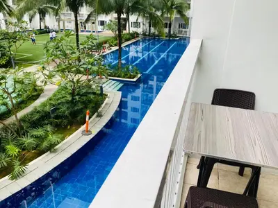 a view of the pool from the balcony of a resort at Shore Residence D3 Shortwalk mall of Asia near airport in Manila