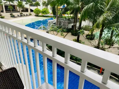 a view of the pool from the balcony of a resort at Shore Residence D3 Shortwalk mall of Asia near airport in Manila