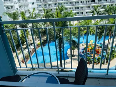 a view of a swimming pool from a balcony at SHELL RESIDENCE C1 shortwalk MALL OF ASIA NEAR AIRPORT in Manila