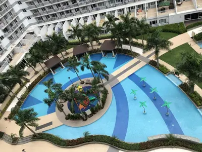 an overhead view of a large swimming pool in a resort at MOA CONDOTEL MANILA in Manila