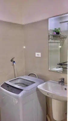 a small bathroom with a toilet and a sink at NJ's Place, Shore 1 Residences, MOA Complex, Pasay City, Philippines in Manila