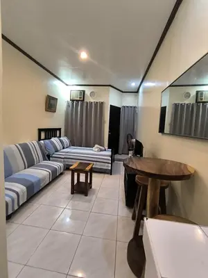 a living room with a couch and a table at South Breeze Balibago 3 minutes away from Santa Rosa Commercial Complex in Macabling