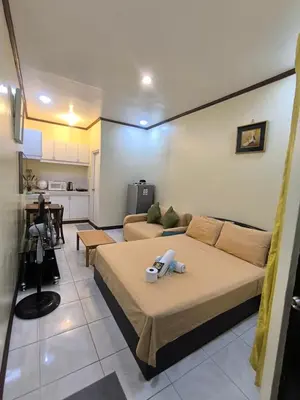 a living room with a bed and a couch at South Breeze Balibago 3 minutes away from Santa Rosa Commercial Complex in Macabling