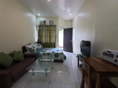 a living room with a couch and a tv at South Breeze Balibago 3 minutes away from Santa Rosa Commercial Complex in Macabling
