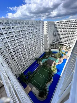 an aerial view of a large building with a tennis court at Studio Units at Shore Residences Condo MOA Complex near Airport in Manila
