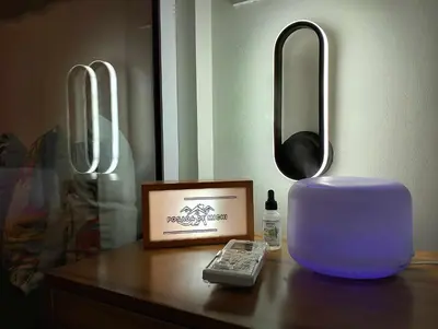 a table with a remote control and a mirror at Posada De Michi - Acqua Private Residences in Manila