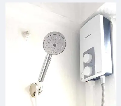 a thermostat on a wall next to a phone at Rooftop Condo Makati in Manila