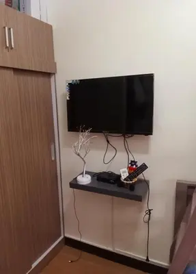 a flat screen tv hanging on a wall at Joey's Place Calathea DMCI in Manila