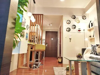 a living room with a couch and a table at SMDC Air Residence-LucasCove Sorrento Vibes in Makati in Manila