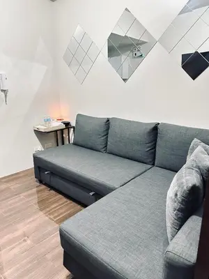 a living room with a couch and a table at Heart of Makati, Fully furnished condo, cbd central location in Manila