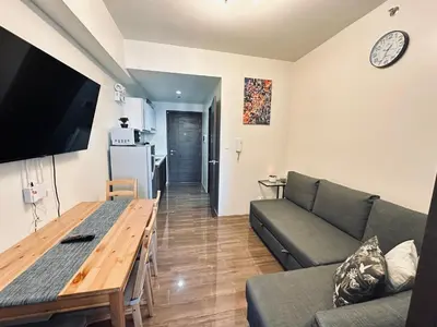 a living room with a couch and a table at Heart of Makati, Fully furnished condo, cbd central location in Manila