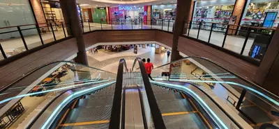 an overhead view of a shopping mall with escalators at Heart of Makati, Fully furnished condo, cbd central location in Manila