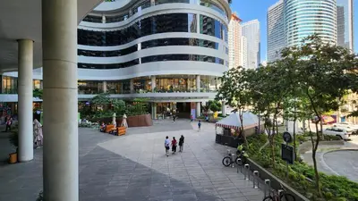 a group of people walking in front of a building at Heart of Makati, Fully furnished condo, cbd central location in Manila