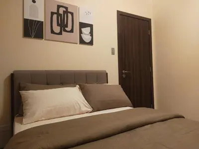a bedroom with a bed with a brown headboard at The Radiance Manila Bay in Manila