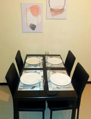 a table with four chairs and plates on it at The Radiance Manila Bay in Manila