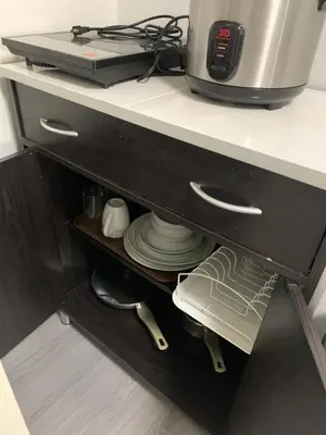 a kitchen counter with a coffee maker on a shelf at Cozy 1 Bedroom near Alabang Town Center and Molito with Wifi and Netflix in Manila
