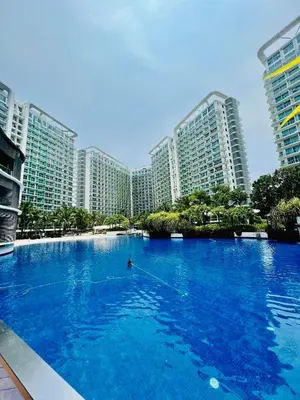 a large swimming pool in front of tall buildings at AZURE URBAN RESORT Maldives tower in Manila