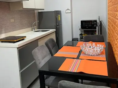 a kitchen with a dining table and a kitchen with a refrigerator at AZURE URBAN RESORT Maldives tower in Manila