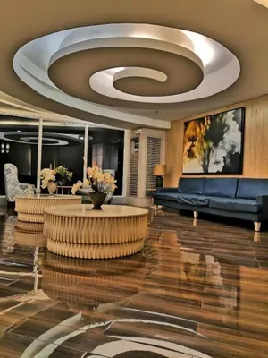 a lobby with a couch and a table in a building at Shore Residence D2 - shortwalk Mall of Asia Near Airport in Manila