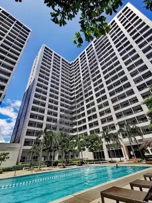 a large building with a swimming pool in front of it at Lot's Pad nr BGC in Manila