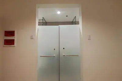 a white refrigerator in a room with a wall at Kaizen Suites in Manila