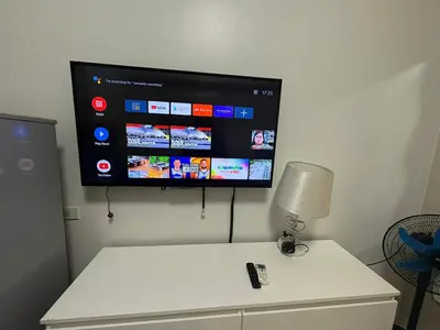 a flat screen tv on a wall in a room at Sea Residences JEREMIAH2911-MALACHI310 in Manila