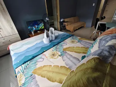 a bed with two stuffed animals on top of it at Bliss Staycation at Sea Residences by John in Manila