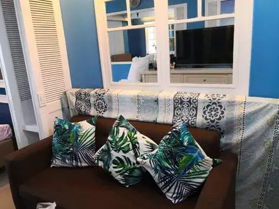 a couch with pillows on it in a living room at Bliss Staycation at Sea Residences by John in Manila