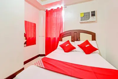 a bedroom with a bed with red pillows at OYO 894 Cosmo Hotel P Campa Manila in Manila