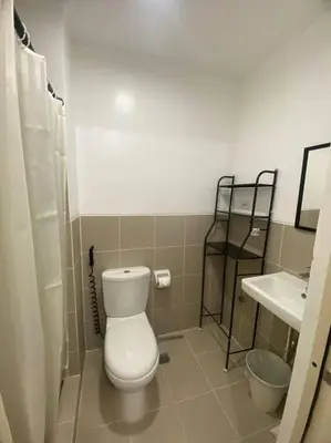 a bathroom with a toilet and a sink at 1BR unit in South Residence Las Pinas with Wifi & Netflix in Manila