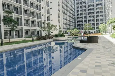 a swimming pool in a building with tall buildings at Fab Staycation @ MOA Complex - Fast Wifi + Netflix in Manila