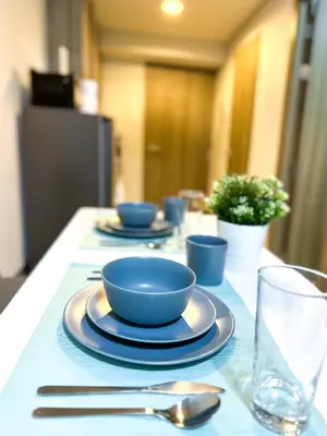 a table with blue bowls and plates on a table at 1 Bedroom Condo near CCP Roxas Boulevard Pasay in Manila