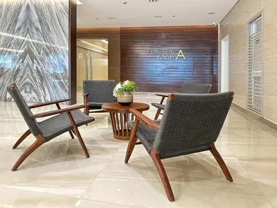 a lobby with chairs and a table in a building at 1 Bedroom Condo near CCP Roxas Boulevard Pasay in Manila