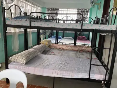 a couple of bunk beds in a room at THE MANSION - BACKPACKERS Near AIRPORT in Manila