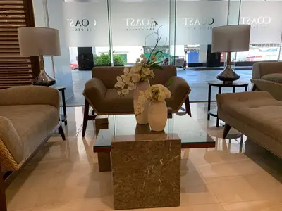 a lobby with a vase of flowers on a table at SMDC Coast Residences Roxas Boulevard corner Pasay Condo Unit in Manila