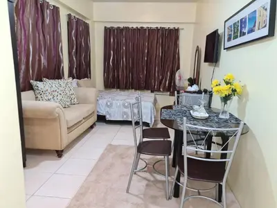 a living room with a couch and a table at Pet Friendly Staycation in in Cainta